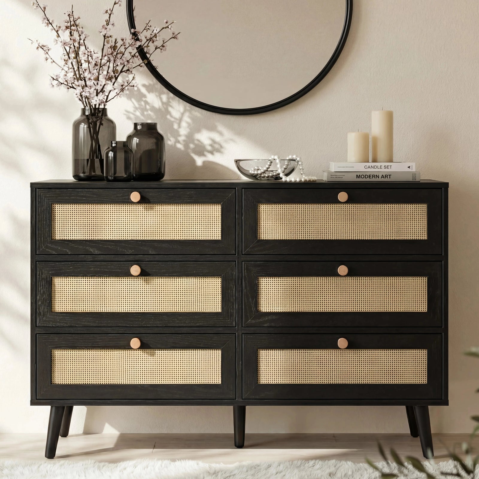 [Black] Wovena rattan chest front view in styled bedroom with round mirror, dried branches in vase and pillar candles on top