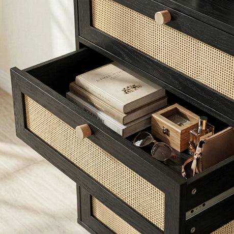 [Black] Wovena rattan chest open drawer interior shown with two books, wooden box and glasses on cane-front base