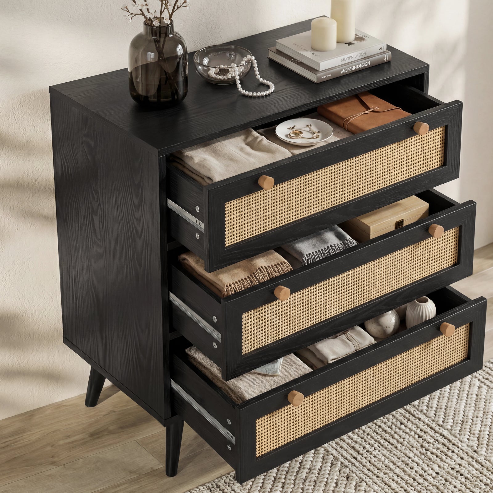 [Black] Wovena rattan chest with all three cane-front drawers open showing 65cm wide interiors
