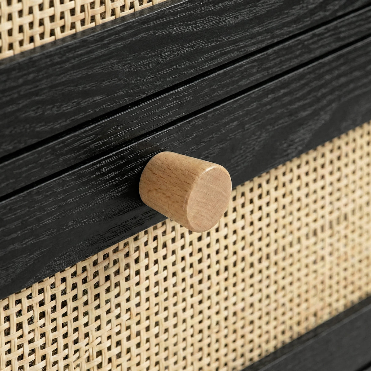 [Black] Wovena rattan chest wood knob close-up mounted on black frame with cane front beside