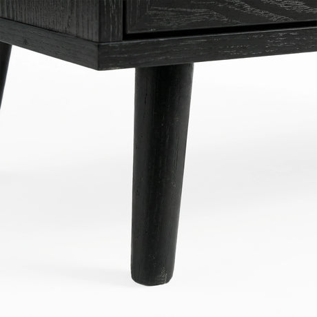 [Black] Wovena rattan chest tapered leg detail at base corner of the black painted frame