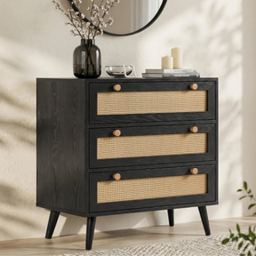 [Black] Wovena rattan chest angled in hallway with round mirror above and dried stems in vase