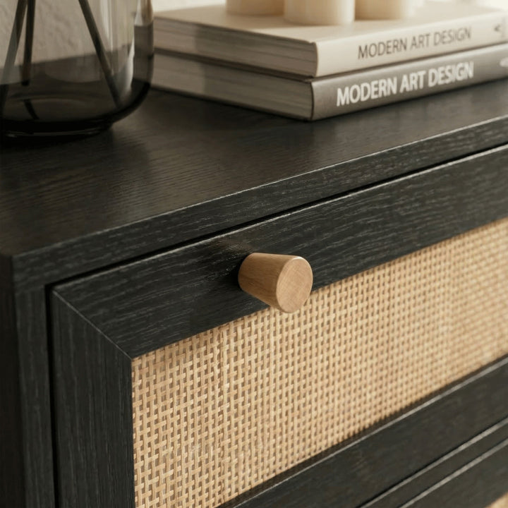 [Black] Wovena rattan tallboy knob close-up against black frame and rattan panel