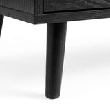 [Black] Wovena rattan tallboy leg detail showing architectural splayed base