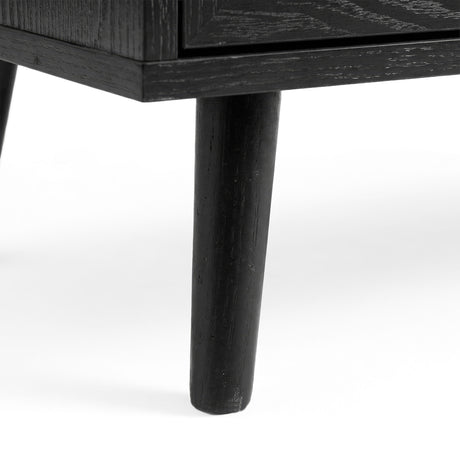 [Black] Wovena rattan tallboy leg detail showing architectural splayed base