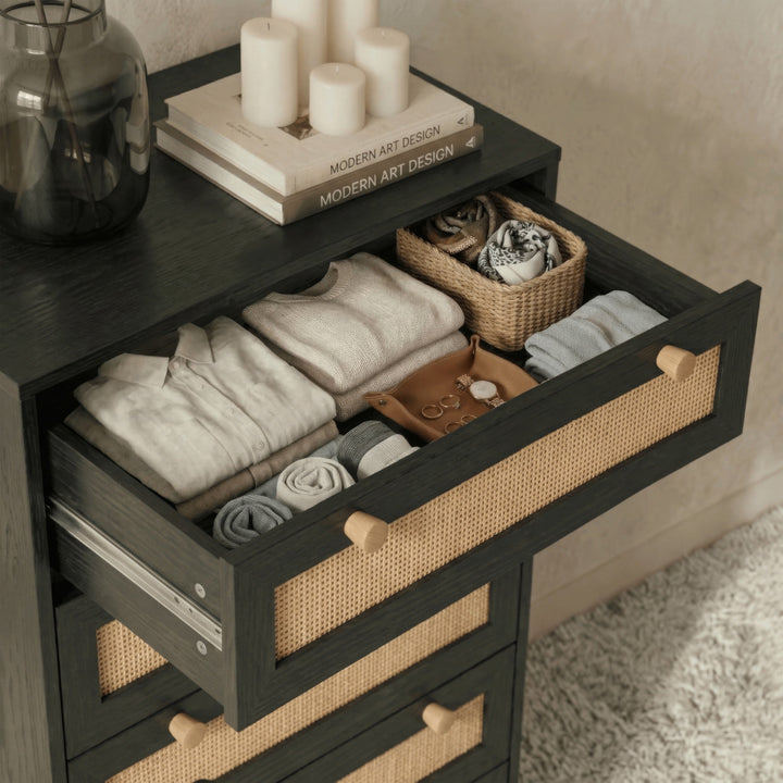 [Black] Wovena rattan tallboy top drawer pulled out filled with folded knitwear