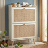 [White] Wovena Rattan White 2 Door Shoe Storage Cabinet angled in blue hallway on herringbone floor with woven basket, succulent, and bowl on top shelf