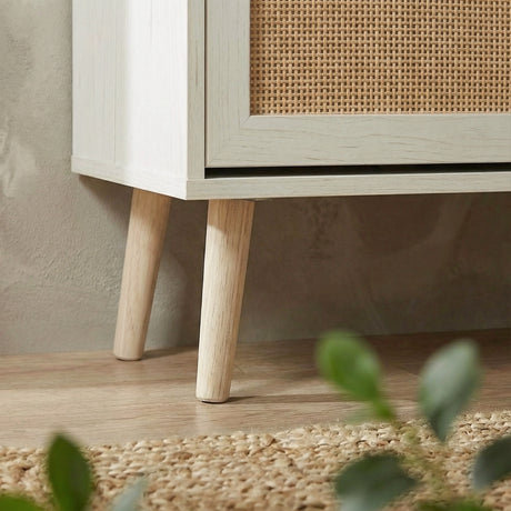 [White] Close-up detail of the splayed pine legs and base of the Wovena shoe cabinet