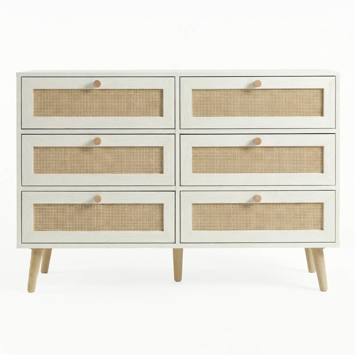 [White] Wovena wide rattan chest in a styled bedroom with all drawers closed and natural dappled light