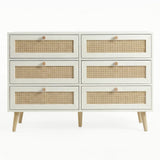 [White] Wovena wide rattan chest in a styled bedroom with all drawers closed and natural dappled light