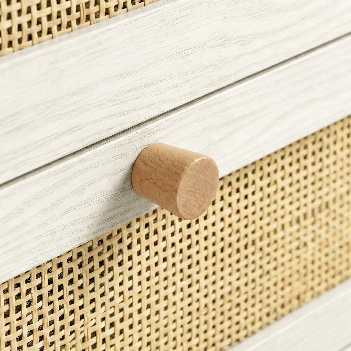 [White] Wovena close-up of round hardwood knob set against rattan cane mesh weave and melamine frame edge