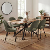Modern dining table with 6 green upholstered chairs, sleek wooden finish with black metal legs and soft light decor.