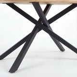 Close-up view of the Xylon dining table's black metal cross legs, a modern and sturdy base for a wooden table top.