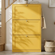 [Yellow]  Shaker Shoe Cabinet closed three-door flip-front unit in hallway setting with woven basket and staircase in background