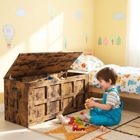 Storage Chest - Shaker Style Blanket or Toy Box With Lid & Safety Hinges in rustic wood finish, open in a child's bedroom with toys inside. Ideal for toy or blanket storage with cutout handles and safety hinges for secure use.