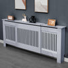 Grey Adjustable Radiator Cover, Extendable 140 - 204 cm | DHS styled in a modern room with decorative items on top shelf.